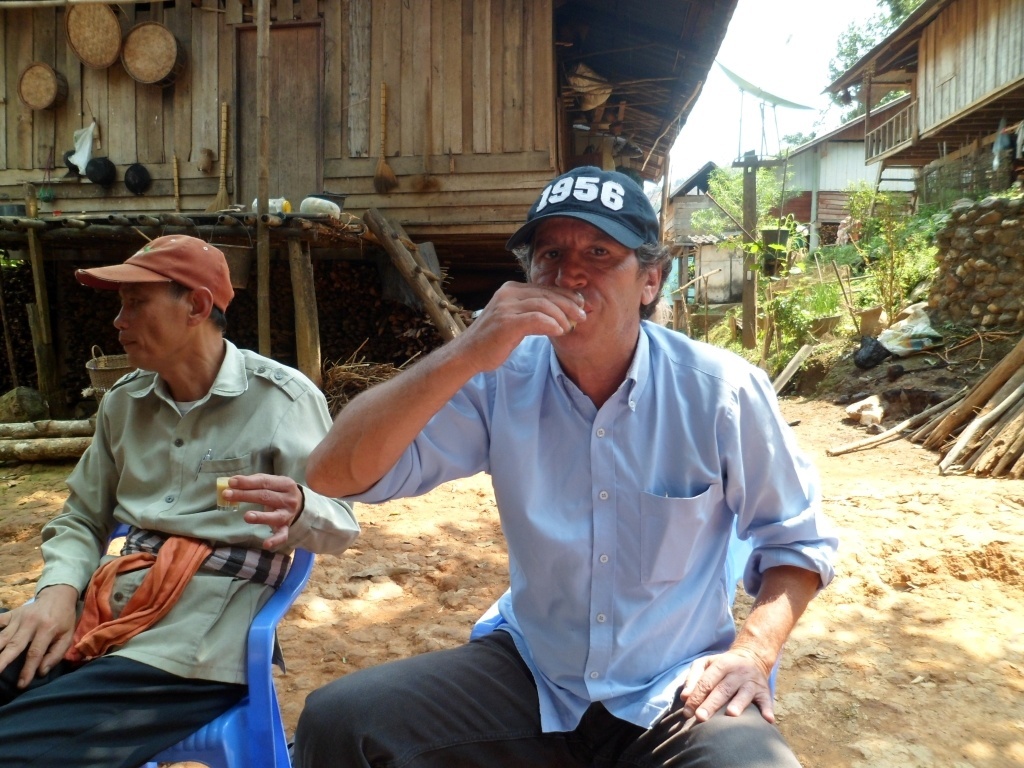 The author Bernie Rosenbloom has a few lao khao in Khone Kham before moving on