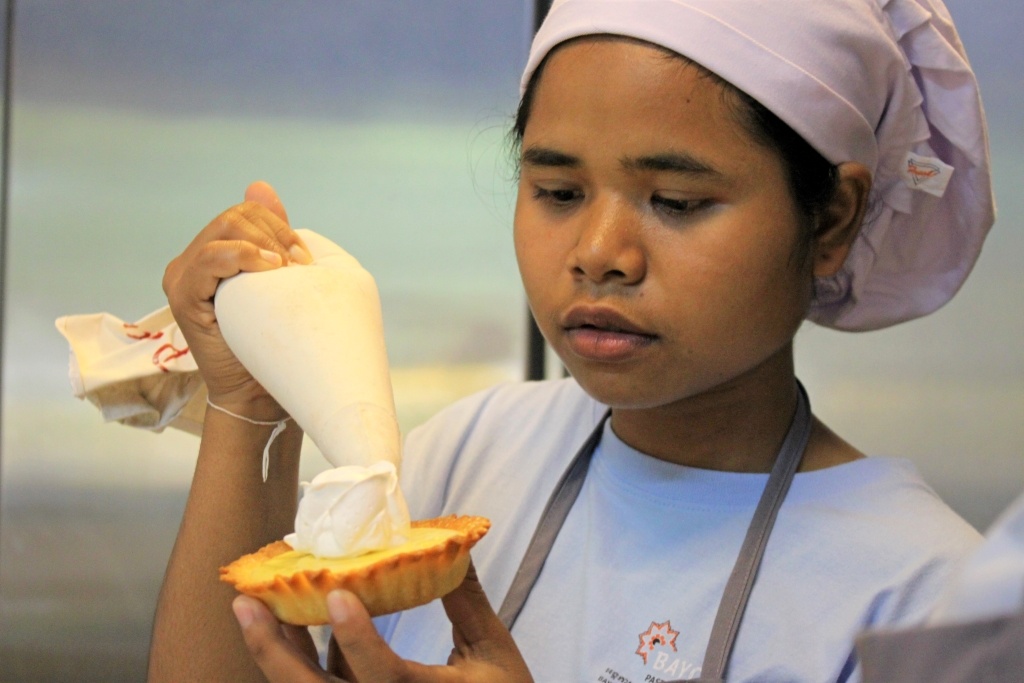 Trainee concentrates at the Bayon Pastry School Coffee Shop in Siem Reap, Cambodia
