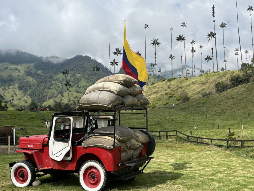 Cocora Valley, Colombia and its wax palm landscape. Are the bags on the jeep filled with coffee beans, palm wax, or potatoes? Image (c) Annaleigh Bonds