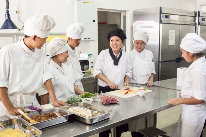 Instruction in the kitchen at HCTC's The Passport restaurant in Mae Sot, Thailand